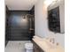 Modern bathroom with dark hexagonal tile and gold fixtures at 335 4Th Ne St, Atlanta, GA 30308