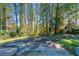 Wooded backyard with a large patio and basketball court at 5382 Kemper Pl, Stone Mountain, GA 30088