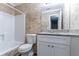 Clean bathroom featuring granite countertop and tile surround at 5382 Kemper Pl, Stone Mountain, GA 30088