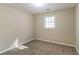 Simple bedroom with carpeted floor and a window at 5382 Kemper Pl, Stone Mountain, GA 30088