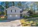 Gray two-story house with a two-car garage and a landscaped yard at 5382 Kemper Pl, Stone Mountain, GA 30088
