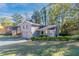 Gray house with a two-car garage, and lush green lawn at 5382 Kemper Pl, Stone Mountain, GA 30088