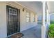 Front porch with white columns, brick exterior, and black security door at 5382 Kemper Pl, Stone Mountain, GA 30088