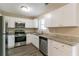Renovated kitchen with white cabinets, granite countertops, and stainless steel appliances at 5382 Kemper Pl, Stone Mountain, GA 30088