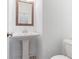 Small bathroom with pedestal sink and toilet at 1309 Bennett Creek Ovlk, Suwanee, GA 30024