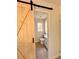 Clean bathroom with barn door entry and toilet at 2815 Highway 20 Se, Conyers, GA 30013