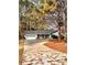 Ranch style home with attached garage, long driveway, and mature trees in the front yard at 2815 Highway 20 Se, Conyers, GA 30013