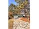 Ranch style home with attached garage, long driveway, and mature trees surrounding the property at 2815 Highway 20 Se, Conyers, GA 30013