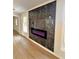 Modern electric fireplace with marble surround and light oak flooring at 2815 Highway 20 Se, Conyers, GA 30013