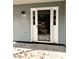 White front door with glass panels and storm door at 2815 Highway 20 Se, Conyers, GA 30013