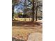 Landscaped front yard with mature trees and a paved driveway at 2815 Highway 20 Se, Conyers, GA 30013