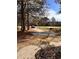 Spacious front yard with mature trees and a paved driveway at 2815 Highway 20 Se, Conyers, GA 30013
