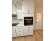 Built-in wall oven and white cabinets in updated kitchen at 2815 Highway 20 Se, Conyers, GA 30013