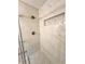 Shower with marble-look tile and pebble floor at 2815 Highway 20 Se, Conyers, GA 30013