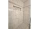 Shower with marble-look tile and pebble floor at 2815 Highway 20 Se, Conyers, GA 30013