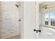 Large marble shower with a frameless glass enclosure at 674 Exchange Se St, Atlanta, GA 30315