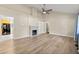 Spacious living room featuring hardwood floors, a fireplace, and built-in shelving at 2627 Elsinore St, East Point, GA 30344