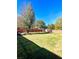 Large backyard with grassy area, wooden fence, and shed at 408 Othello Dr, Hampton, GA 30228
