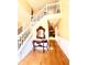 Two-story entryway featuring hardwood floors, a staircase, and a console table at 408 Othello Dr, Hampton, GA 30228