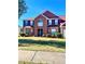 Two-story brick house with a large front yard and a two-car garage at 408 Othello Dr, Hampton, GA 30228