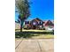 Two-story brick home with a tree in the front yard and a driveway at 408 Othello Dr, Hampton, GA 30228