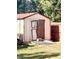 Outdoor storage shed with double doors in backyard at 408 Othello Dr, Hampton, GA 30228