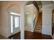 Two-story entryway with hardwood floors, arched doorways, and a staircase at 168 Waypoint Dr, Stockbridge, GA 30281