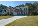 Two-story brick home with a front yard and driveway at 168 Waypoint Dr, Stockbridge, GA 30281