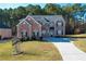 Two-story brick home with a large driveway and landscaped lawn at 168 Waypoint Dr, Stockbridge, GA 30281
