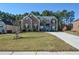 Two-story brick home with a large front yard and driveway at 168 Waypoint Dr, Stockbridge, GA 30281