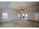 Main bedroom with fireplace, carpet, and access to bathroom at 168 Waypoint Dr, Stockbridge, GA 30281