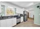 White cabinets, granite countertops, and stainless steel appliances in this kitchen at 2175 Starlite Way, Snellville, GA 30078