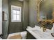 Elegant powder room with dark green walls and gold accents at 1032 Baldwin Dr, Milton, GA 30009