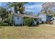 Ranch style home with light blue exterior, landscaping, and a driveway at 1965 Meadow Ln, Decatur, GA 30032