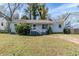 Cute ranch home with light blue exterior, landscaped yard, and driveway at 1965 Meadow Ln, Decatur, GA 30032