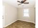 Well lit bedroom with hardwood floors and ceiling fan at 2021 Dennis Pl, Buford, GA 30519