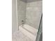 Bathroom with a bathtub and marble tile shower surround at 711 Cosmopolitan Ne Dr # 426, Atlanta, GA 30324