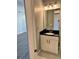 Small bathroom with vanity, marble-tiled floors, and a mirror at 711 Cosmopolitan Ne Dr # 426, Atlanta, GA 30324