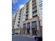 Modern multi-story building with brick and light-colored siding, balconies, and covered entryway at 711 Cosmopolitan Ne Dr # 426, Atlanta, GA 30324