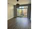 Bright living room with hardwood floors, sliding glass doors to balcony, and modern light fixture at 711 Cosmopolitan Ne Dr # 426, Atlanta, GA 30324