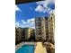 Community swimming pool with surrounding patio furniture and views of building at 711 Cosmopolitan Ne Dr # 426, Atlanta, GA 30324