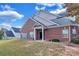 Brick townhouse exterior showcasing a side view and landscaping at 2555 Flat Shoals Rd # 1801, Atlanta, GA 30349