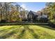 Modern home with lush green lawn and autumn trees at 2716 Ridgewood Nw Rd, Atlanta, GA 30327