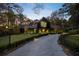 Modern home with a long driveway and black metal fence at 2716 Ridgewood Nw Rd, Atlanta, GA 30327
