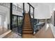 Grand staircase with open risers and modern metal railing at 2716 Ridgewood Nw Rd, Atlanta, GA 30327