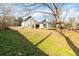 Spacious backyard with a playset, trampoline, and home view at 4900 Lilburn Stone Mountain Sw Rd, Lilburn, GA 30047