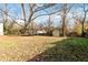 Large backyard with trampoline, shed, and mature trees at 4900 Lilburn Stone Mountain Sw Rd, Lilburn, GA 30047