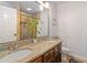 Bathroom with double vanity, granite countertop, and a large mirror at 4900 Lilburn Stone Mountain Sw Rd, Lilburn, GA 30047