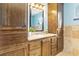 Bathroom with granite countertop, large wooden cabinets, and tiled floor at 4900 Lilburn Stone Mountain Sw Rd, Lilburn, GA 30047