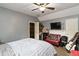 Cozy bedroom with striped bedding, a red chair, and a guitar at 4900 Lilburn Stone Mountain Sw Rd, Lilburn, GA 30047